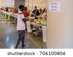 Small photo of Houston, Texas, August 30, 2017: Another shelter opens at NRG Center as refugees seek safety in Houston. A flood evacuee holding a small child receives necessary supplies