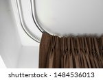 Brown Curtains On A Rail With A ...