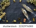 Champagne glasses with colorful glitter confetti with bottle of sparkling wine, celebrate flat lay