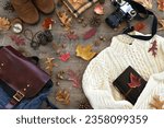 Small photo of Autumn travel outing hiking flat lay - accessories for leaf peeping, going on a hike, bird watching