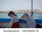 Small photo of Paphos, Cyprus - May 29th, 2019: Woman and man being seasick in a tourist boat.
