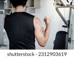 Small photo of Sportive man feeling upper arm muscle pain after doing weight training exercise in fitness gym. Male athlete suffering from acute bicep muscular inflammation symptom. Sport injury concept