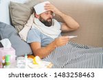 High temperature concept. Man feels badly ill. How to bring fever down. Cold symptoms and causes. Sick man with flu. Man hold thermometer. Measure temperature. Break fever remedies.