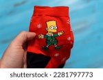 Small photo of Tyumen, Russia-January 23, 2023: Socks with the image of Bart Simpson. The Simpsons is an American adult animated sitcom created by Matt Groening