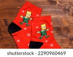 Small photo of Tyumen, Russia-January 23, 2023: Bart Simpson from The Simpsons animated series logo on clothes, Christmas socks