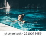 Woman relaxing in the swimming pool.