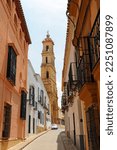 Small photo of Utrera, Spain; May 15 2022: Rodrigo Caro street with the church of Santa Maria de la Mesa in Utrera, Seville province, Andalusia, Spain