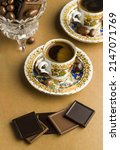 Small photo of Traditional Turkish Coffee on brown kraft paper surface with madlen chocolates.Conceptual image for celebrations.