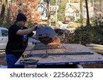 Young Man Cutting Steel Rebar...