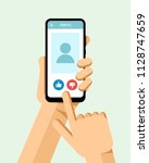 hand holds the smartphone with... | Shutterstock .eps vector #1128747659