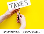 tax reduce concept. hands with... | Shutterstock . vector #1109710313