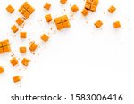Small photo of Salted caramel pieces - paradoxical sweets - on white background top view copy space