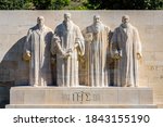 Small photo of Front view of the four statues at the center of the Reformation Wall in the Parc des Bastions in Geneva, Switzerland, representing John Calvin and the Calvinism's main proponents, on a sunny day.