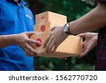 Small photo of Delivery man holding boxes person who sent the letter to the package box to the recipient to arrive at home