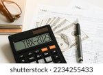 Small photo of Tax 2023. Word Tax 2023 on calculator. Business and tax concept .Calculator, currency, dollar bills close up. Income Statement. paying the tax rate. Taxation, taxes burden. Business concept.