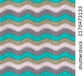 Small photo of Seamless knitted pattern in the form of zigzags is crocheted with multi-colored threads. Acrylic baby yarn. Pastel shades.