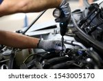 Small photo of Close-up on automechanic hands checking automobile parts. Machine details necessarily used for perfect auto functionality in modern engineering service station. Automotive checkup concept