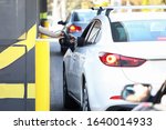 Convenient payment from car, drive thru system. Payment for services credit card using pos terminal. Customer purchases goods without leaving his car. Drivers are charged certain fare.