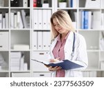 Small photo of Female medicine doctor hand hold jar of pills and write prescription to patient at worktable. Panacea and life save, prescribing treatment, legal drug store concept. Empty form ready to be used