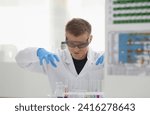 Small photo of Employee of the chemical laboratory chemist teacher nurtures a sly plan in anticipation of an interesting conception that needs to be solved plans is plotting now a rogue.