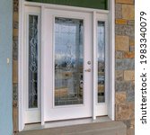 Small photo of Square Beautiful glass front door with sidelights and transom window at the home facade. Row of window are installed on the stone exterior wall.