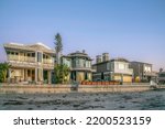 Homes at Del Mar Southern California overlooking beach and sea at sunset. Upscale two-storey seaside houses with balconies at a peaceful and quiet neighborhood.