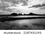 Landscpae of Mountain and Lake with Silhouette of People Working in Field in Lopuri Thailand