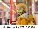 Child, boy, wearing protective mask in underground. Sid in subway in Prague, wearing mask
