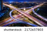 Small photo of Aerial angle Rush hour traffic fast moving hyper lapse at night overhead of busy intersection traffic at night moving fast light road lane effect line light cg