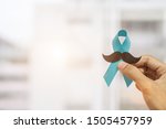 Small photo of November Prostate Cancer Awareness month, Man holding Blue Ribbon with mustache for supporting people living and illness. Healthcare, International men, Father and World cancer day concept