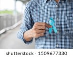 Small photo of November Prostate Cancer Awareness month, Man in blue shirt with hand holding Blue Ribbon for supporting people living and illness. Healthcare, International men, Father and World cancer day concept