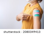 Small photo of woman showing plaster after receiving covid 19 vaccine. Vaccination, herd immunity, side effect, booster dose, vaccine passport and Coronavirus pandemic