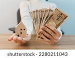 Small photo of Woman holding Japanese Yen banknote and House model. Real Estate, Home, Mortgage, Japan cash, Tax, Recession Economy, Inflation, Investment, finance and savings concepts