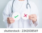 Doctor show Wrong symbol paper. True and false, accept and rejected, evaluation, Diagnosis, Vote, Poll, Yes or No, Health, Medical and Survey concepts