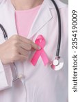 Small photo of Pink October Breast Cancer Awareness month, doctor with pink Ribbon in hospital for support people life and illness. National cancer survivors month, Mother and World cancer day concept