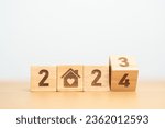 Small photo of Happy New Year 2024 with Home and Heart block. Property investment, House Mortgage, Real Estate tax, homeless, donation, Financial and happy family concepts