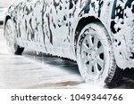 
Washing  black car with active foam
