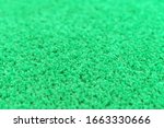 Bright green carpet pile, texture. Focus with shallow depth of field.