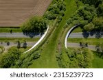 Small photo of Green wildlife crossing seen from above forming a safe natural corridor bridge for animals to migrate between conservancy areas. Environment nature reserve infrastructure eco passage.