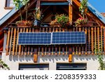 Small photo of Solar battery on balcony wall of vintage house in Germany. Balcony Mini photovoltaic power plant. Mini PV plants generate your own electricity plug play. Small Solar Panel energy system.