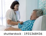 Small photo of Angry female caregiver grimacing,facial expression of dissatisfaction in helping for the disabled old elderly patient in bed room,reluctantly service and care for the sick senior woman in nursing home