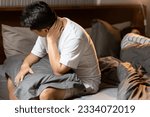 Small photo of Middle aged man holding pillow,discomfort and pain in neck,shoulder,muscle strain or sprain,neck stiffness,difficulty moving the neck,problem of bad pillow or poor posture,wrong sleeping positions