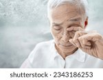 Small photo of Old elderly rubbing her eyes,itchy discomfort,pain and itchiness in eye,infections and irritation from dust particles,allergies to pollen or smog in the air,senior woman suffer eye-related diseases