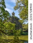 Small photo of Sibyl temple on the hill and lake in Buttes Chaumont Park, Paris, France.