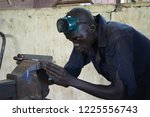 Small photo of Kakuma refugee camp, Kenya - May 2018: Young man practising plumbing in Don Bosco vocational training centre. Tertiary education for refugees.
