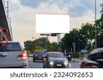 A blank billboard on one of Thailand's streets, a blank billboard with copy space for text or content, mockup of a blank billboard in a big city, evening scene. Space for your ad.
