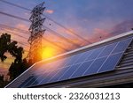 Solar panel on the roof, electrical wires on the rear background, alternative energy. Solar cells with radiation ot the sun and power pole. Power generation through solar energy
