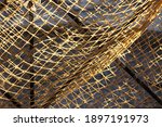 Small photo of Fish Net Background. Restaurant Wall Interior Or Exterior Decorated With Old Hanging Fishnet. Fishing Net Abstract Texture With Knotted Pattern. Fishnet Wallpaper. Design Element With Retro Fish Net.