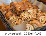 A lot of sweet pastries in baskets on the buffet table. Business breakfasts and catering at events. Close-up.