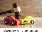 Small photo of Hammer gavel judge with car vehicle accident, insurance coverage claim lawsuit court case.